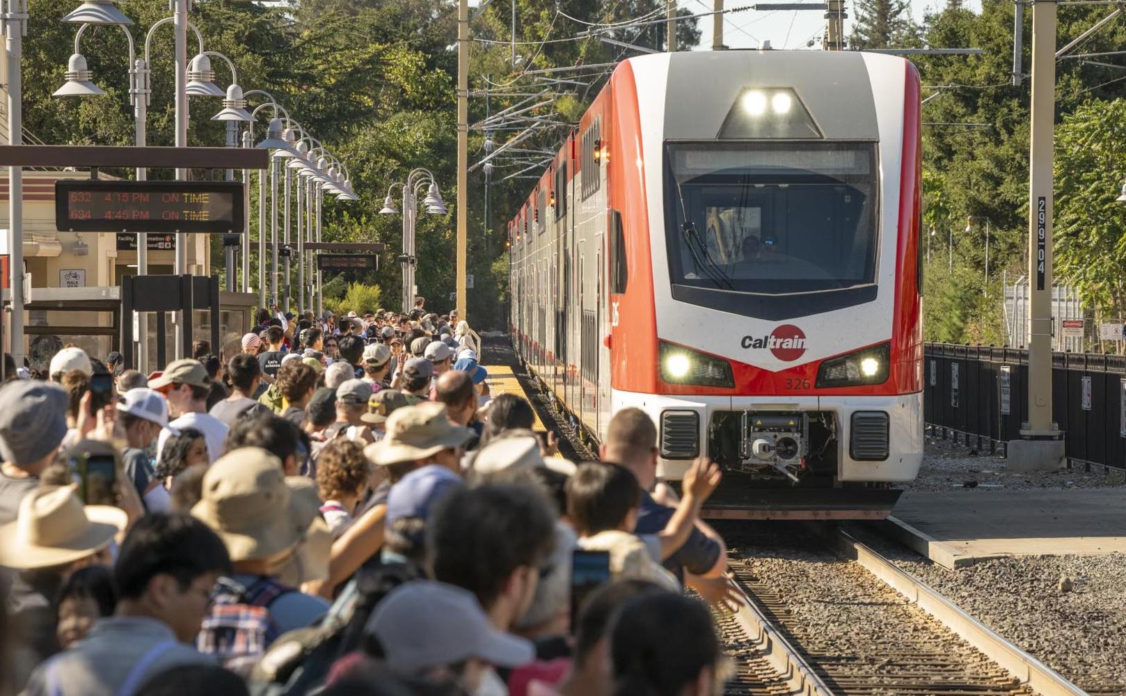 Crowd watches electric train arrive at Palo Alto Station