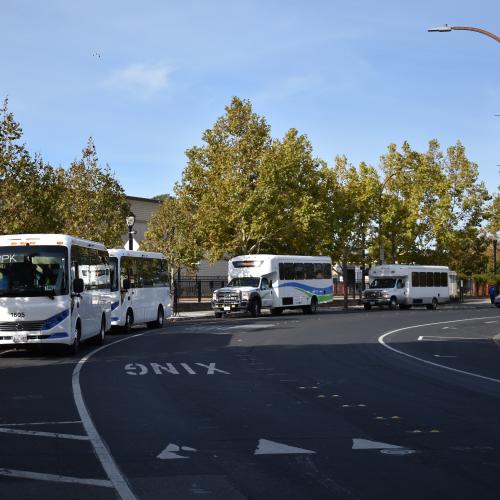 Picture of multiple shuttles at the Redwood City Caltrain Station