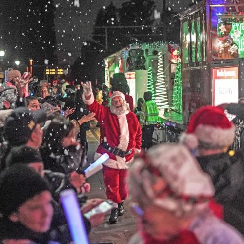 Santa waves at revelers in front of the Holiday Train