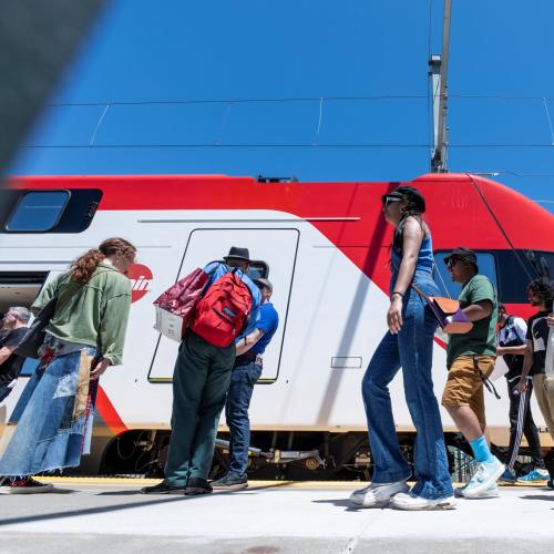 People looking at new electric train at public tour