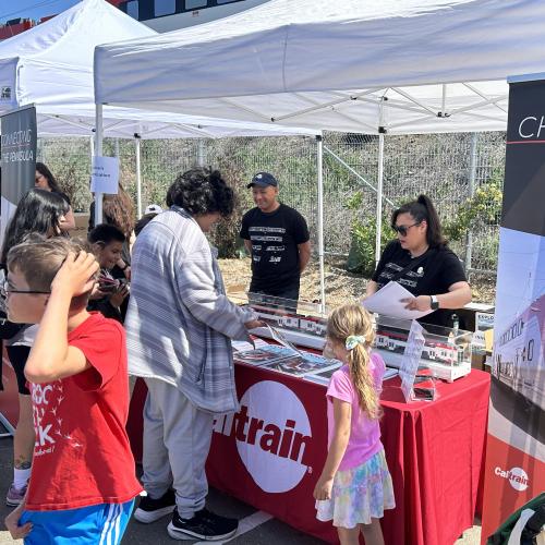 Onlookers visit Caltrain Tent at EMU event