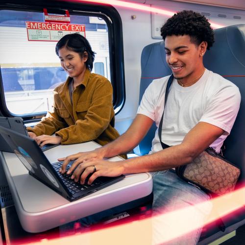 Passengers accessing train WiFi with their laptops